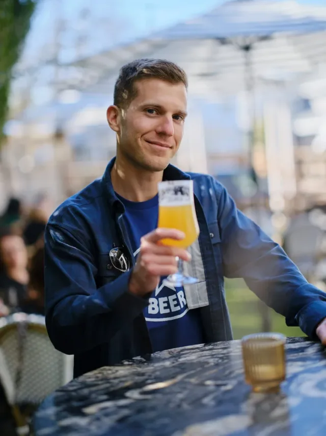 Man holding a craft beer at an outdoor patio, a lifestyle dating profile photo by Austin online dating photographer Eli Samuel
