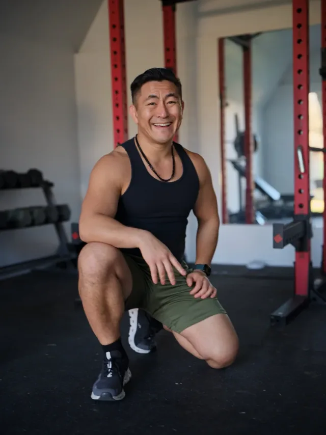 Athletic man smiling in a gym setting, a fitness lifestyle dating profile photo by Austin photographer Eli Samuel