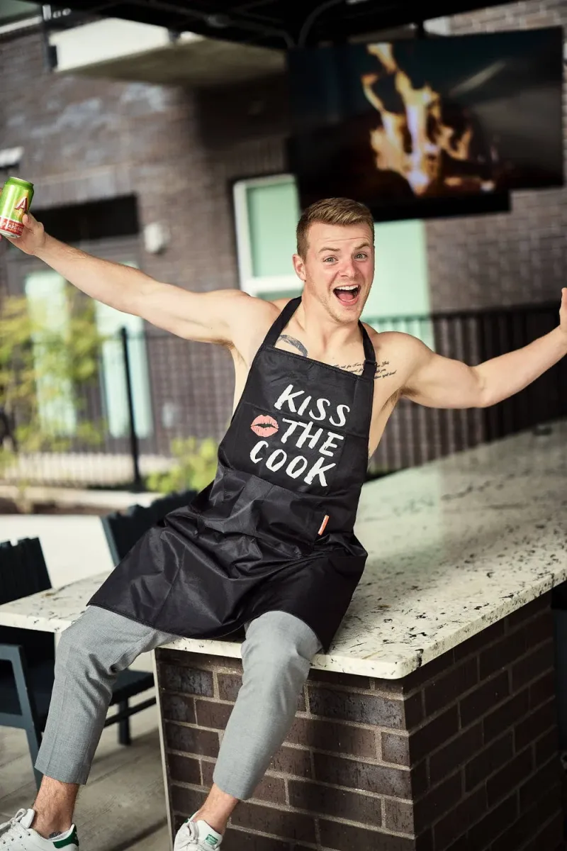 Man smiling at the camera in a natural lifestyle dating profile photo